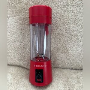 BlendJet One Portable Red Blender with USB charging cord and diffuser/lid.